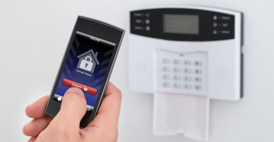 Professional Alarm System Installation Services in the GTA Professional technician installing a modern smart home security system with doorbell camera and control panel in a Toronto residence