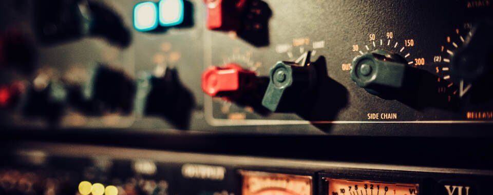 Technician adjusting wall-mounted speaker for optimal sound output
